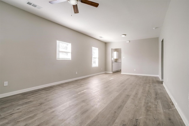 spare room featuring hardwood / wood-style floors and ceiling fan