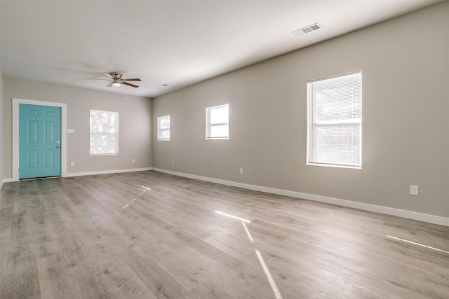 unfurnished room with ceiling fan and light wood-type flooring