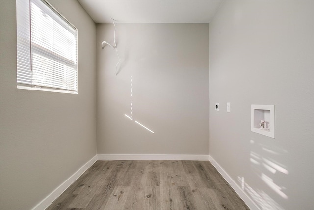 laundry area featuring washer hookup, light hardwood / wood-style flooring, and electric dryer hookup