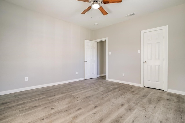 spare room featuring light hardwood / wood-style flooring and ceiling fan