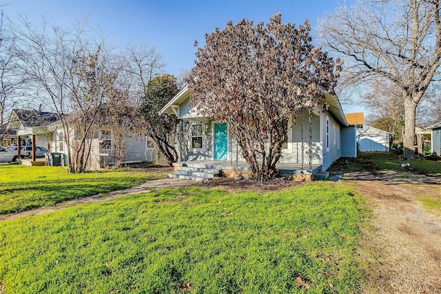 view of property hidden behind natural elements with a front yard