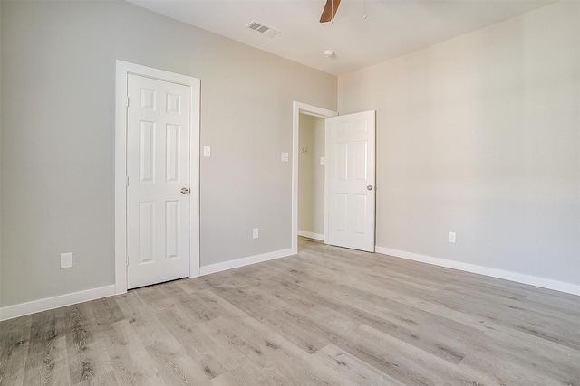 spare room featuring light hardwood / wood-style floors and ceiling fan