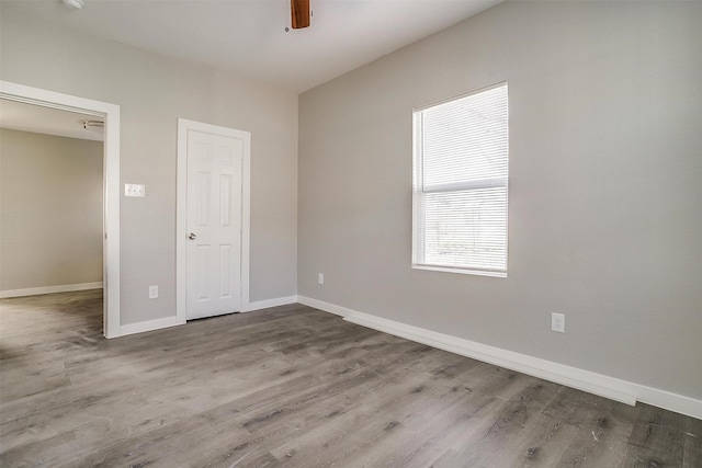 empty room featuring ceiling fan and hardwood / wood-style floors