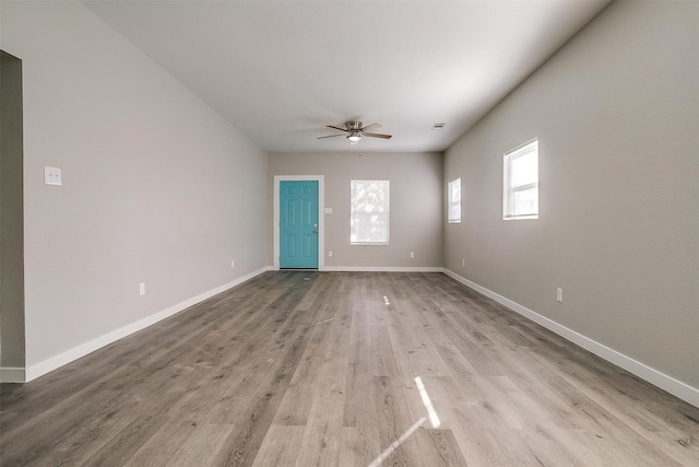 empty room with light hardwood / wood-style flooring and ceiling fan