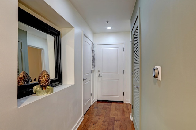 hallway with hardwood / wood-style floors