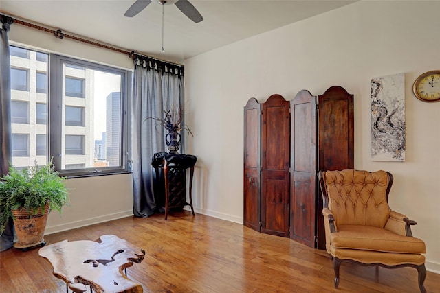 sitting room with ceiling fan and light hardwood / wood-style floors