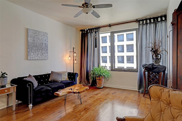 living room featuring ceiling fan, plenty of natural light, and light hardwood / wood-style floors