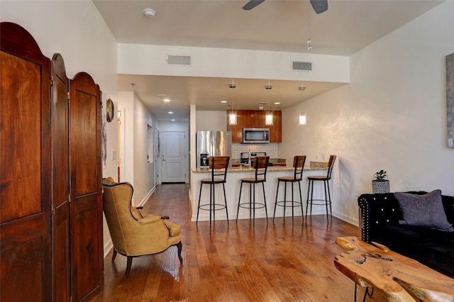 living room featuring ceiling fan and wood-type flooring