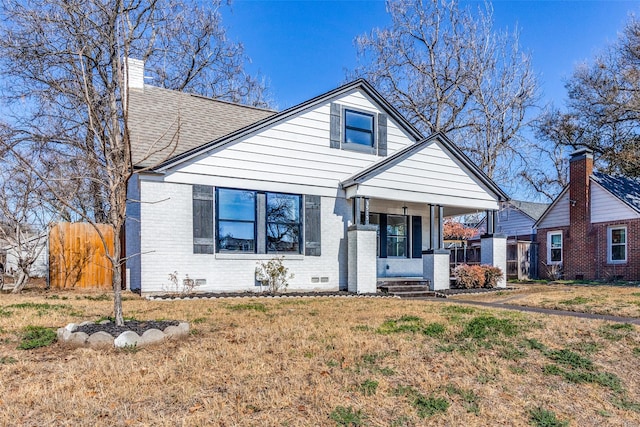 bungalow-style home featuring a porch and a front lawn