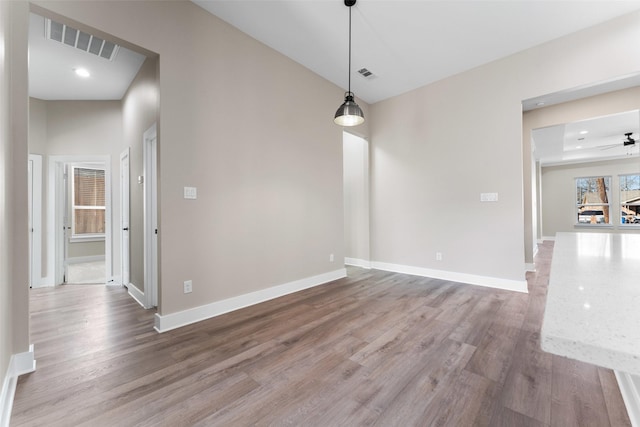 unfurnished dining area with wood-type flooring and ceiling fan