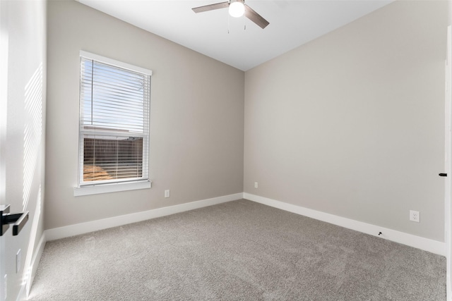 carpeted spare room with ceiling fan