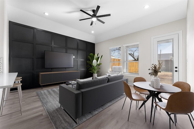 living room featuring ceiling fan and light hardwood / wood-style floors