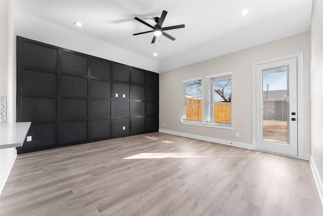 empty room with light hardwood / wood-style flooring and ceiling fan