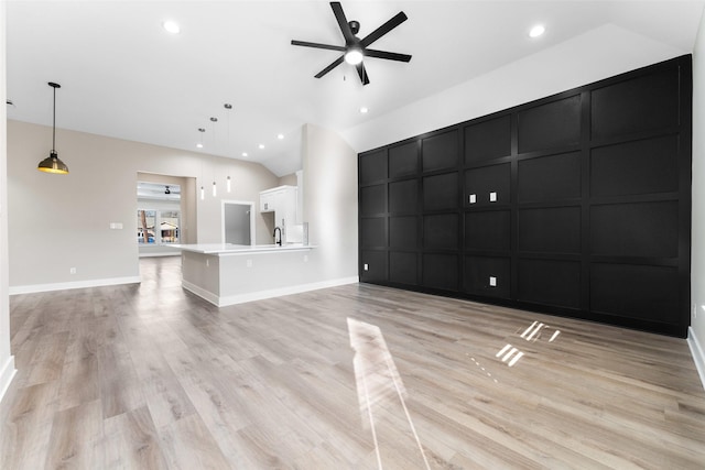 unfurnished living room featuring ceiling fan and light wood-type flooring