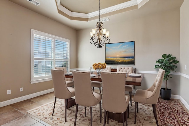 dining room featuring a chandelier, crown molding, and a raised ceiling