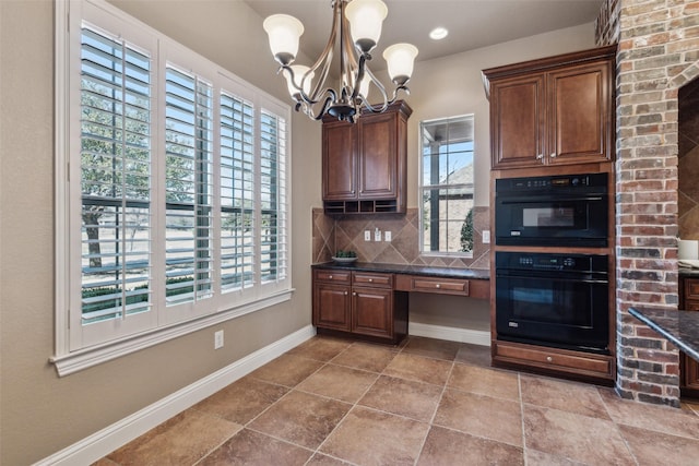 kitchen featuring double oven, decorative backsplash, built in desk, and plenty of natural light