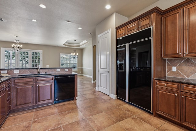 kitchen featuring a notable chandelier, decorative light fixtures, sink, and black appliances