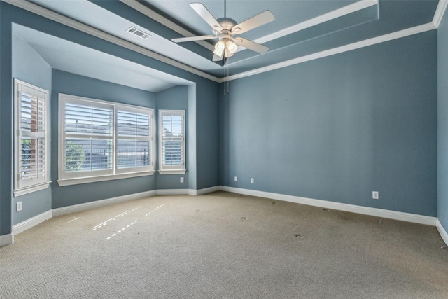 spare room featuring crown molding, ceiling fan, a tray ceiling, and carpet flooring