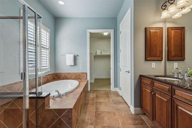 bathroom with independent shower and bath and vanity