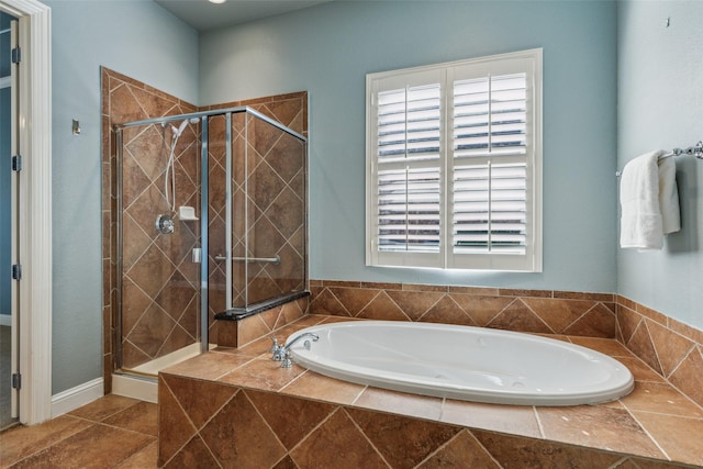 bathroom featuring tile patterned floors, a healthy amount of sunlight, and separate shower and tub