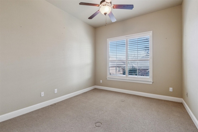 spare room with light carpet and ceiling fan