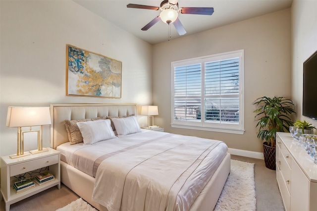 bedroom with ceiling fan and light carpet