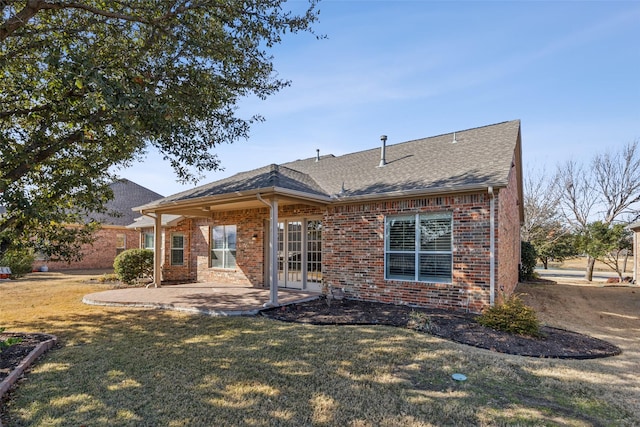 back of property with a yard and a patio area