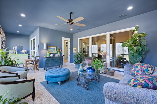 living room with ceiling fan and carpet flooring