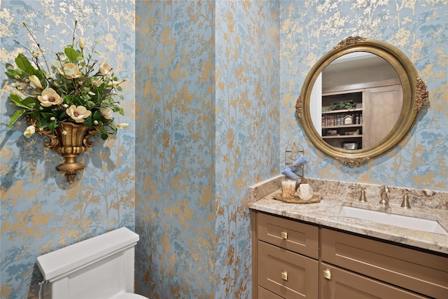 bathroom featuring vanity and toilet