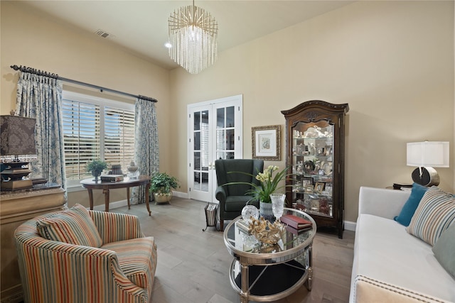 living room featuring an inviting chandelier and light hardwood / wood-style flooring