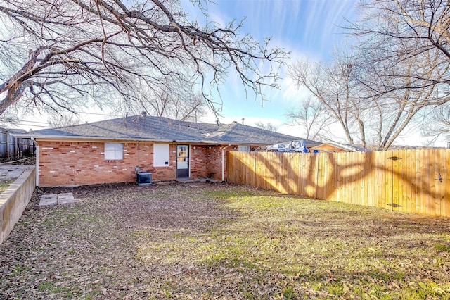 rear view of property featuring a lawn