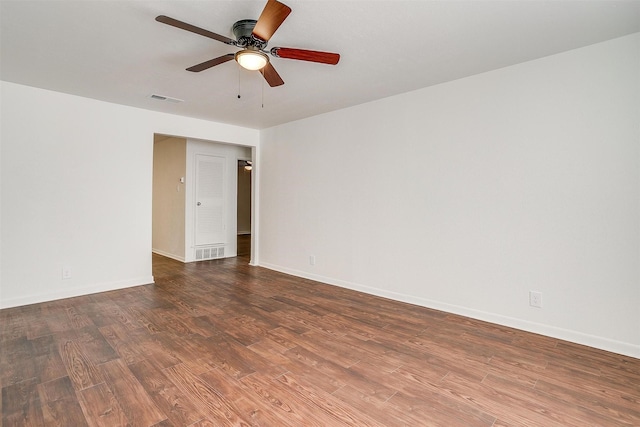 empty room with ceiling fan and dark hardwood / wood-style flooring