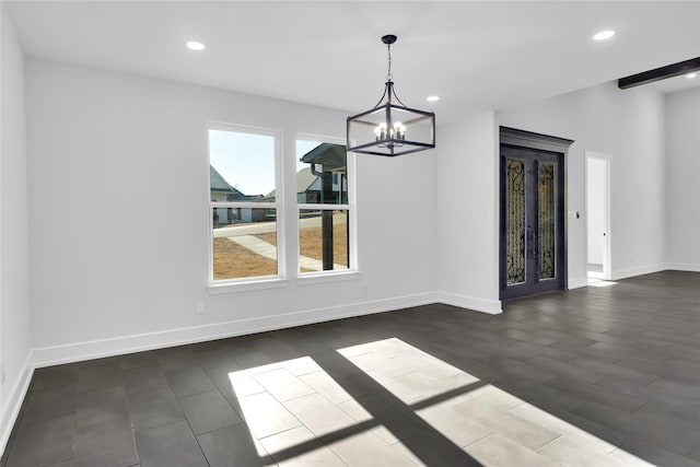 unfurnished dining area featuring recessed lighting, baseboards, and an inviting chandelier