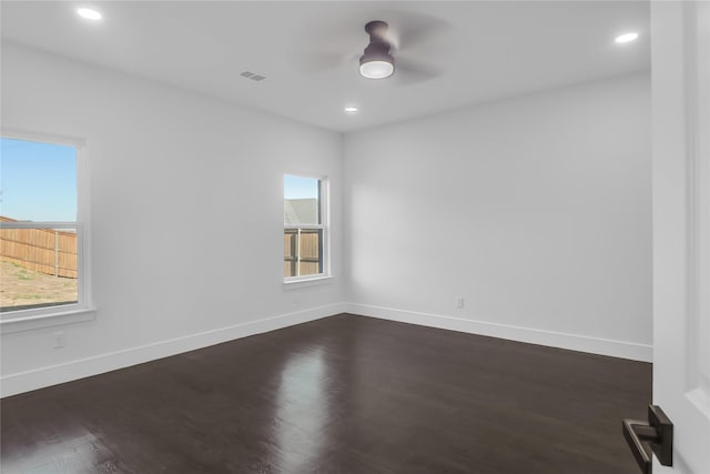 spare room featuring visible vents, baseboards, a ceiling fan, dark wood-style flooring, and recessed lighting