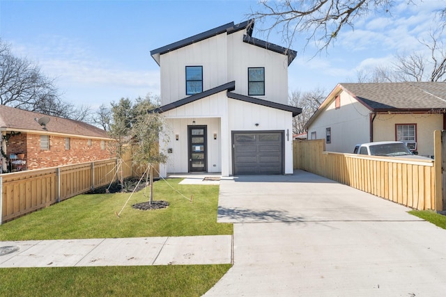 view of front facade featuring an attached garage, fence, driveway, a front lawn, and board and batten siding