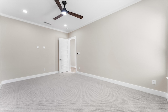 unfurnished room with baseboards, visible vents, light colored carpet, ornamental molding, and recessed lighting