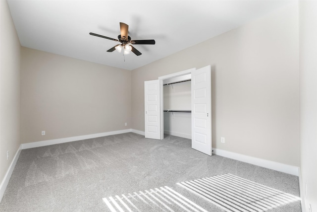 unfurnished bedroom with a ceiling fan, a closet, baseboards, and carpet flooring