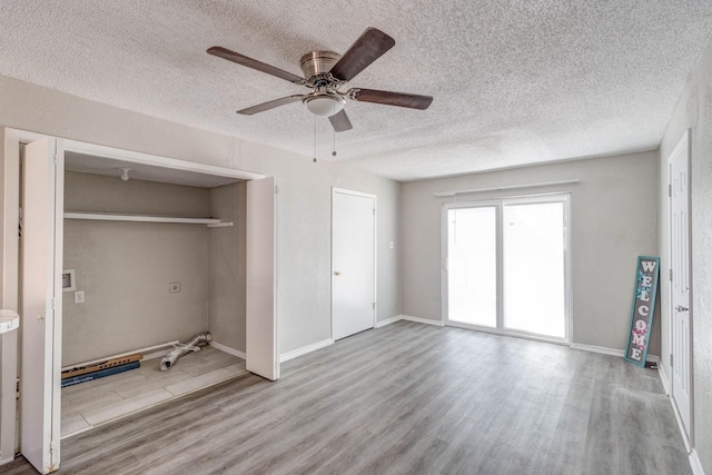 unfurnished bedroom with light hardwood / wood-style flooring, a closet, and ceiling fan