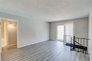 unfurnished room with hardwood / wood-style floors