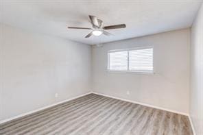 unfurnished room featuring ceiling fan and light wood-type flooring