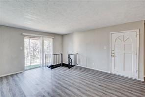 unfurnished room with dark wood-type flooring