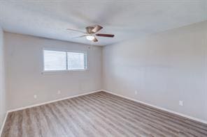 empty room featuring ceiling fan and light hardwood / wood-style flooring