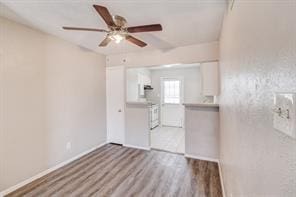 spare room with hardwood / wood-style floors and ceiling fan