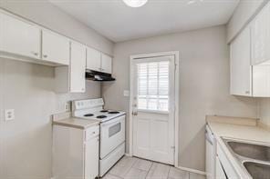 kitchen featuring sink, exhaust hood, light tile patterned floors, white range with electric stovetop, and white cabinets