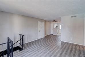 unfurnished living room with ceiling fan and hardwood / wood-style floors