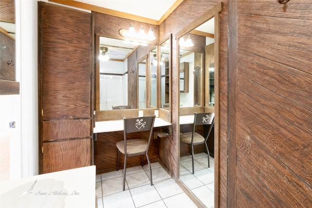 bathroom featuring vanity, tile patterned floors, and wooden walls