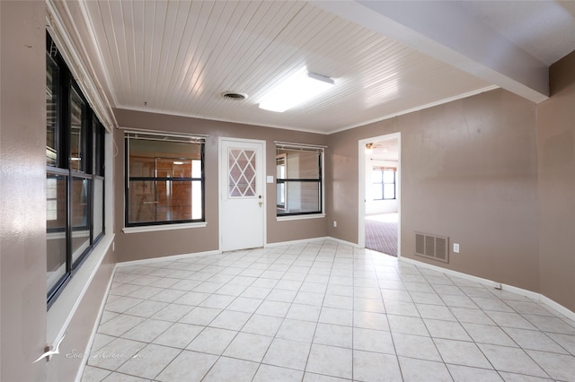 tiled spare room with ornamental molding