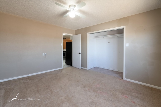 unfurnished bedroom with ceiling fan, light carpet, a closet, and a textured ceiling