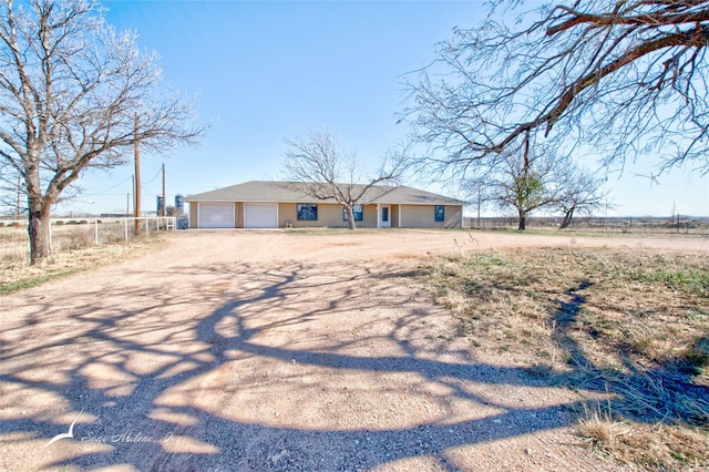 view of front of house with a rural view and a garage