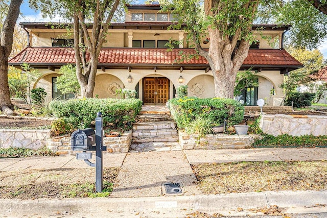 view of front of house featuring french doors and a balcony